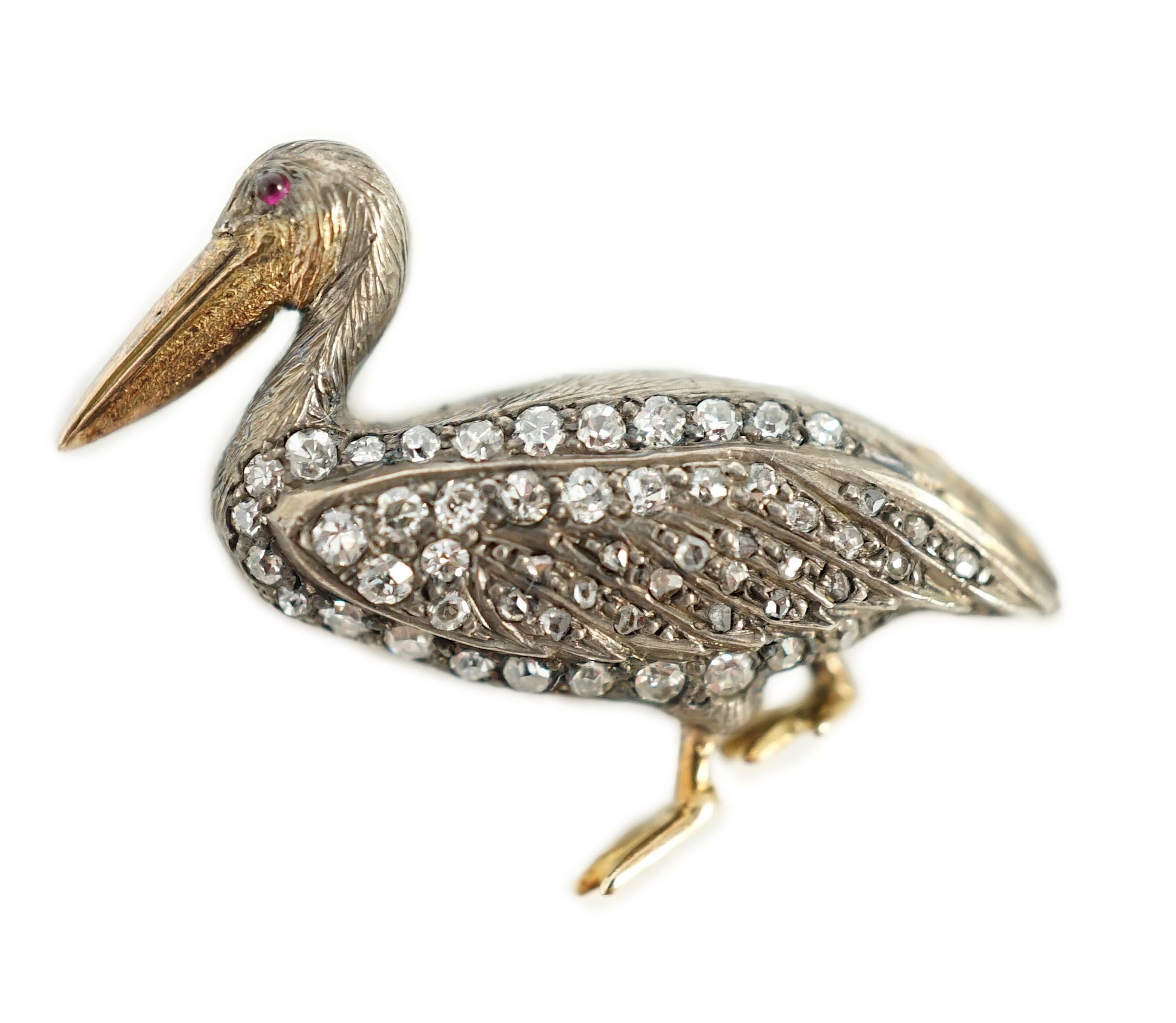A Victorian style diamond encrusted and ruby set brooch, modelled as a pelican